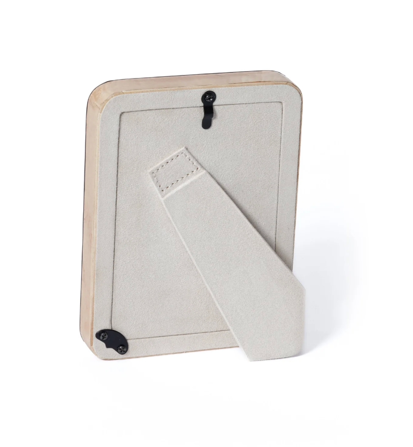 The Valari Burl Veneer Frame by Zodax features natural wood, a beige suede-like stand, and two black hooks for vertical or horizontal display.