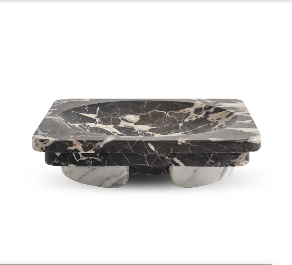 Rectangular black and white Caldera - Marble Bowl by Greg Natale, featuring a rounded inner section and supported by two arched marble bases, displayed against a plain white background. This sophisticated decorative bowl is a striking accent that elevates any contemporary space.