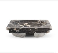 Rectangular black and white Caldera - Marble Bowl by Greg Natale, featuring a rounded inner section and supported by two arched marble bases, displayed against a plain white background. This sophisticated decorative bowl is a striking accent that elevates any contemporary space.