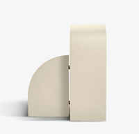 The Cubist Bookend Left - Stone Leather by Assouline is pictured standing upright against a white background, showcasing its geometric, semicircular side profile and smooth stone leather texture—evoking the clean lines and sculptural elegance of modernist décor.