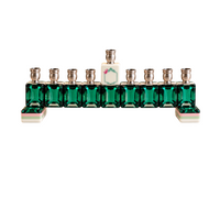 Eclectic Judaica Mah Jong Menorah - Green Emerald, a nine-branched menorah featuring emerald green glass tiles as the base, topped with silver candle cups and a central white tile with a floral detail.