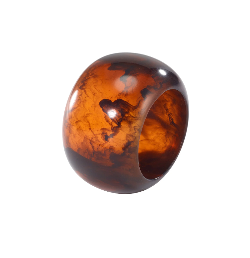 A spherical Sphere Napkin Ring Set of 4 - Tortoise with a brown and amber tortoiseshell pattern.