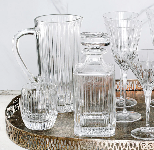 A decorative tray holds Vietri's Natalia Pitcher, a square decanter with stopper, a round tumbler, and stemmed glasses—all featuring matching vertical stripes.