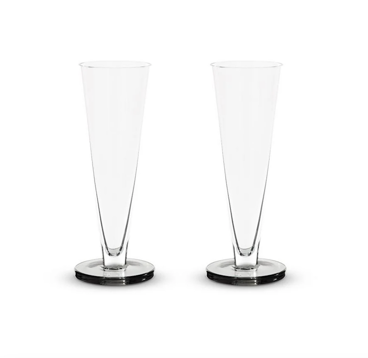 Two empty, clear Tom Dixon Puck Flute Glasses (Set of 2) are standing side by side on a plain white background.