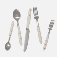 The Blue Pheasant Jones Flatware Ivory set includes five stainless steel pieces with white handles and three silver dots: small spoon, large spoon, knife, large fork, and small fork. All utensils are dishwasher safe.