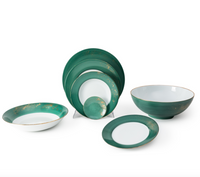 The Molecot Golden Green Dinnerware set includes green and white plates, bowls, and a serving dish with gold porcelain detailing, elegantly arranged on a white background.