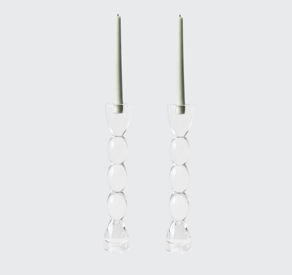 The Lainy Home Crystal Oval Candlesticks Set of 2, made of stacked clear glass spheres and topped with tall pale green candles, are displayed against a light gray background for an elegant, sophisticated look.