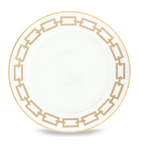 A beige ceramic plate from Ginori 1735's Catene Cachemire collection, featuring a gold geometric border of interconnected rectangles and a thin gold rim around the edge.