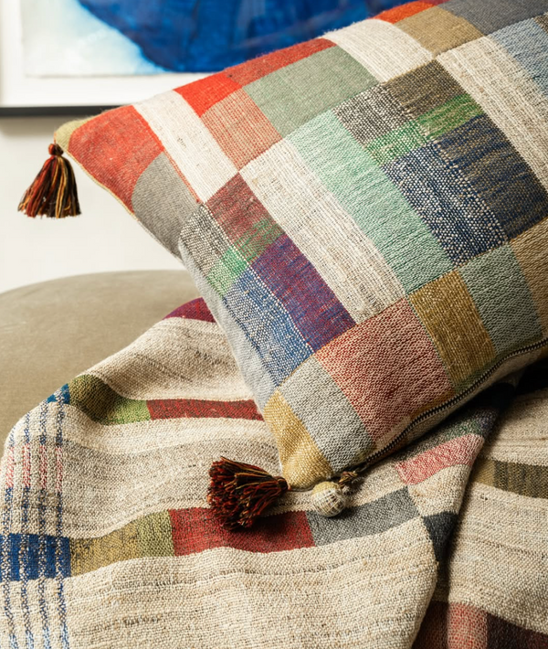 The Lexi Handwoven Pillow 16 x 24 by Threads Soft Goods showcases earthy tones with colorful stripes, plaid patterns, and tassels.