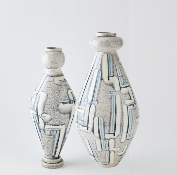 The Spindel Vase Grey Blue by Global Views/Surya features two Portuguese ceramic vases with a speckled gray finish and abstract blue and white linear designs, each hand-painted with rounded shoulders and narrow necks, displayed on a plain light background.