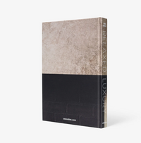 Relaxed Luxury by Assouline is a hardcover book with a minimalist cover—textured beige on top, solid black below—standing upright against a white background; perfect for interior design inspiration.