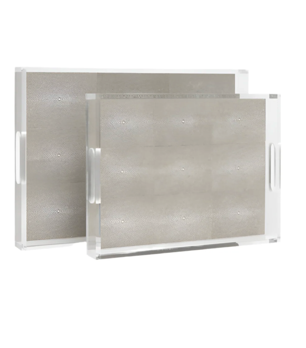 Two Savra Tray Sand - Large trays by Made Goods are displayed, each with a beige, textured faux shagreen interior, visible tunnels and chambers, side handles for easy carrying, and stacked one in front of the other.