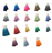 The Johanna Howard Dip Dye Throw collection features 17 throws, each with a vibrant gradient in blue, pink, brown, yellow, green, purple, red, orange, or gray—beautifully displayed on a white background.