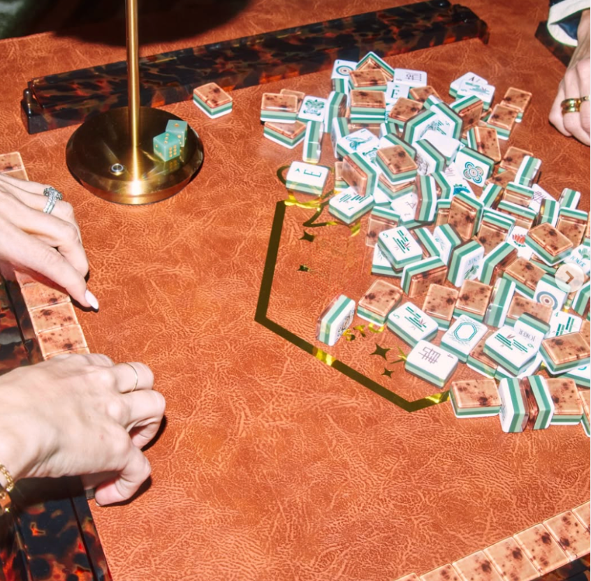 Gather around with friends and the Oh My Mahjong Rack & Pusher Set - Tortoise Shell for a stylish game night, complete with tiles, dice, and golden accents—everything you need for an unforgettable evening.