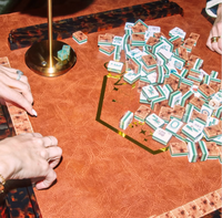 Gather around with friends and the Oh My Mahjong Rack & Pusher Set - Tortoise Shell for a stylish game night, complete with tiles, dice, and golden accents—everything you need for an unforgettable evening.