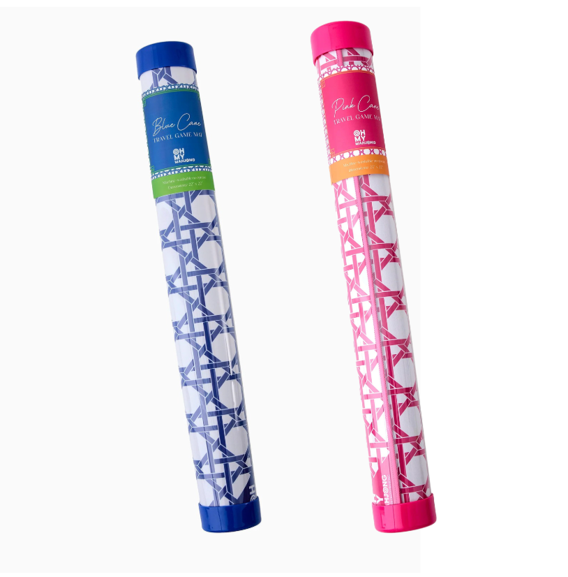 Two Oh My Mahjong Travel Mini Mahjong Game Mats in cylindrical packaging: one blue and white with a blue cap, one pink and white with a pink cap. Each 22”x22”, ideal for travel, features colorful top labels.