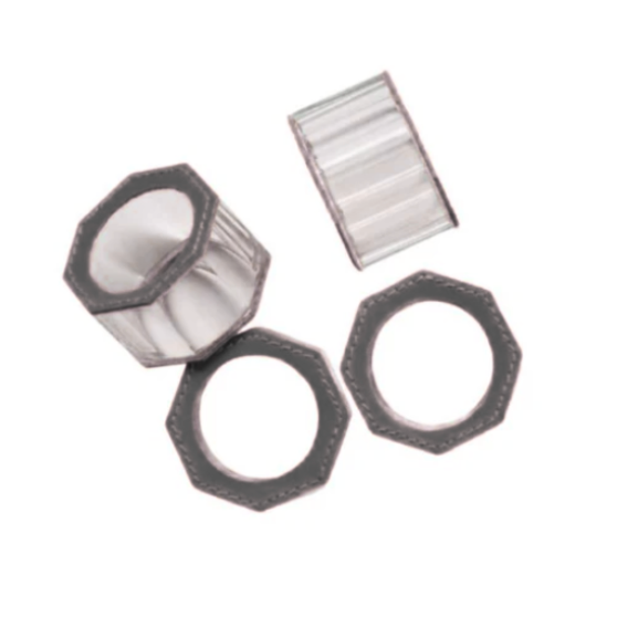 Set of four Arthur Napkin Rings in dark grey by Blue Pheasant, featuring clear octagonal crystals with dark edges, two upright and two flat on a white background.