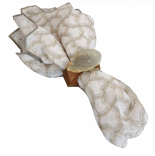 The Iza Silva Gemstone Napkin Ring Set of 4 in grey features large oval accents, adding elegant, natural stone style to your table setting when paired with a geometric beige cloth napkin.