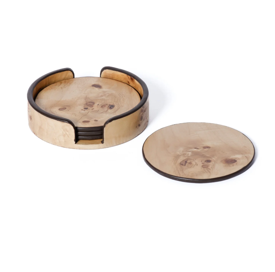 The Zodax Valari Burl Veneer Coaster Set of 4 features a round wooden holder with dark edges, containing decorative drink coasters, and one matching coaster displayed outside the holder on a white background.