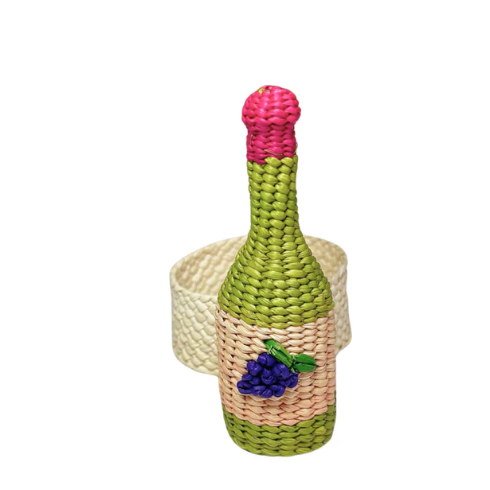 The Coro Cora Wine Napkin Ring Set of 4 features handcrafted, bottle-shaped decor in green, pink, and beige with a grape motif, paired with coiled beige napkin rings—Colombian artisanal table accents on a white background.