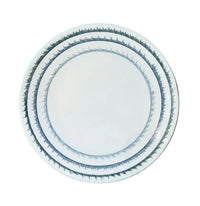 Three white plates of varying sizes from the Marie Daage Sisal 1 Dinnerware collection by Marie Daâge, each adorned with a blue-green geometric tree motif along the rim, are stacked neatly against a white background, showcasing the elegance and artistry of hand-painted luxury porcelain.