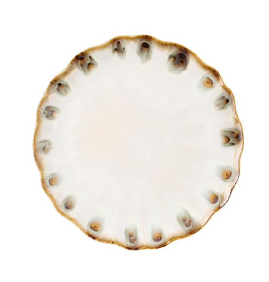 The Amoria Dinnerware by Blue Pheasant features a round ceramic plate with a wavy, scalloped edge and brownish accents along the rim, offering vintage-inspired elegance perfect for any table setting.
