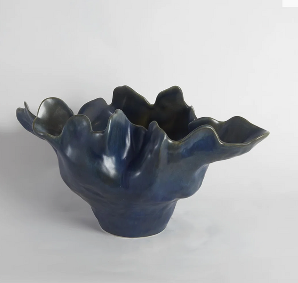 The Meteor Bowl Blue - 22″ by Global Views / Surya is an artisan ceramic piece in deep blue, showcasing a sculptural, organic form and an irregular wavy rim, finished with a striking reactive glaze and displayed against a plain white background.