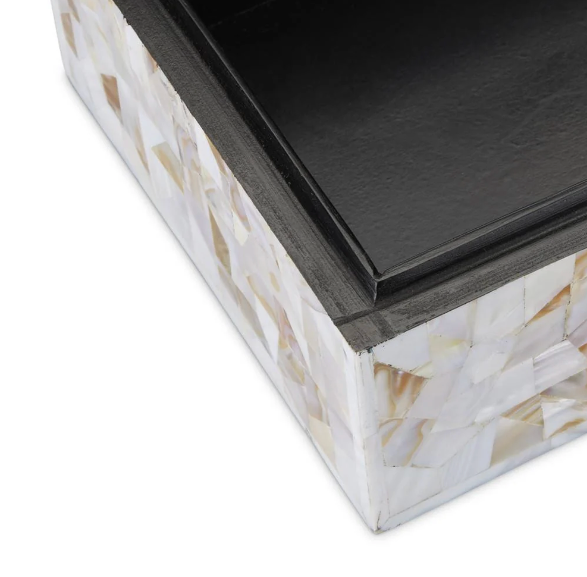 Close-up of the corner of the Simplicity Mother of Pearl Box - Large by Currey & Company, featuring a black lid and a base embellished with a white and beige mother-of-pearl mosaic pattern.