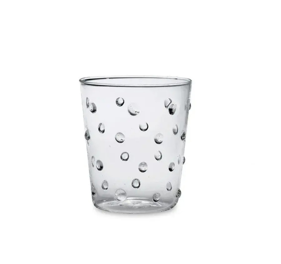 The Zafferano Party Dots Large Tumbler Set of 6 in Clear features 15.2oz glass tumblers with an evenly distributed raised polka dot texture, displayed against a plain white background. Part of our colorful party glassware collection, these stylish and unique polka dot glasses are perfect for brightening up any occasion.