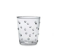 The Zafferano Party Dots Large Tumbler Set of 6 in Clear features 15.2oz glass tumblers with an evenly distributed raised polka dot texture, displayed against a plain white background. Part of our colorful party glassware collection, these stylish and unique polka dot glasses are perfect for brightening up any occasion.