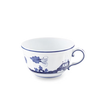 Ginori 1735 Oriente Italiano Indaco white porcelain teacup in the Antico Doccia style, featuring a blue rim and delicate floral and landscape patterns.