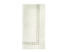 Beige Pearls Napkin Set of 4 with a border of embroidered circular details along two adjacent edges.