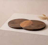 Two overlapping Erin Cheeseboard - Circles acacia wood serving boards with a contrasting light wood accent in the center.