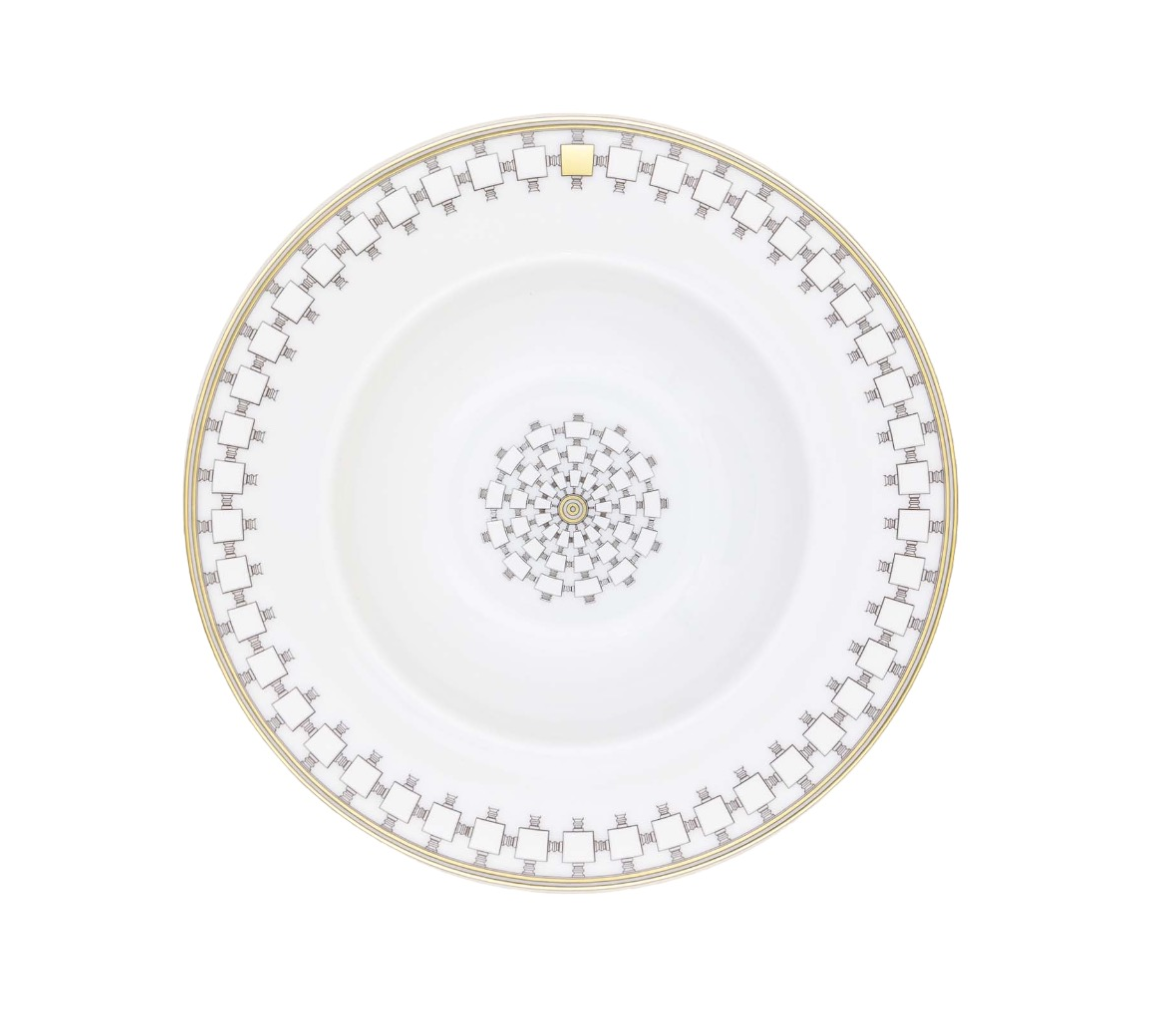 A Mottahedeh/Robert Haviland Home Dinnerware- Gold porcelain bowl featuring a gold rim and a geometric pattern of gray squares and gold accents around the border and in the center.