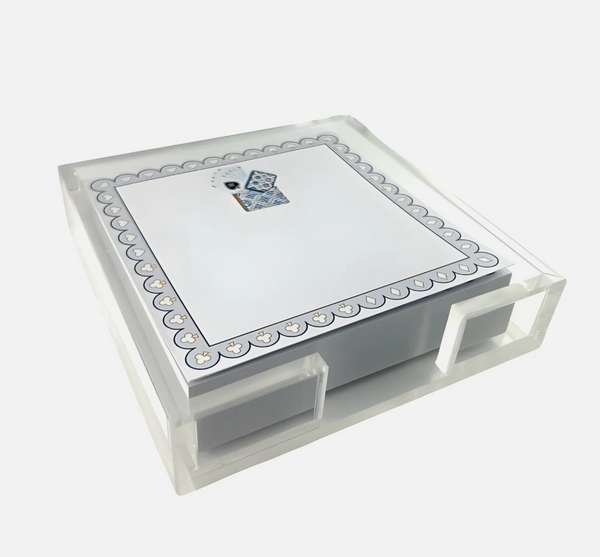 A Maven Home Playing Cards Notepad & Holder consisting of a stack of square memo pad notes in a clear acrylic holder, featuring a border of playing card suit icons and a small illustration of two playing cards at the top.