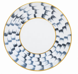 Marie Daâge Zephyr 1 dinner plate in hand-painted white porcelain, featuring a wide border of dark, brushstroke-style markings and a thin gold rim.