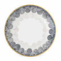 Marie Daâge Cercle D’Ecailles Platinum Filet round Limoges porcelain plate with a gold rim and a border of overlapping grey and white scalloped patterns.