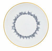 Marie Daâge Iris 1 dinner plate with a thin gold rim and a circular pattern of grey brushstrokes in the center.