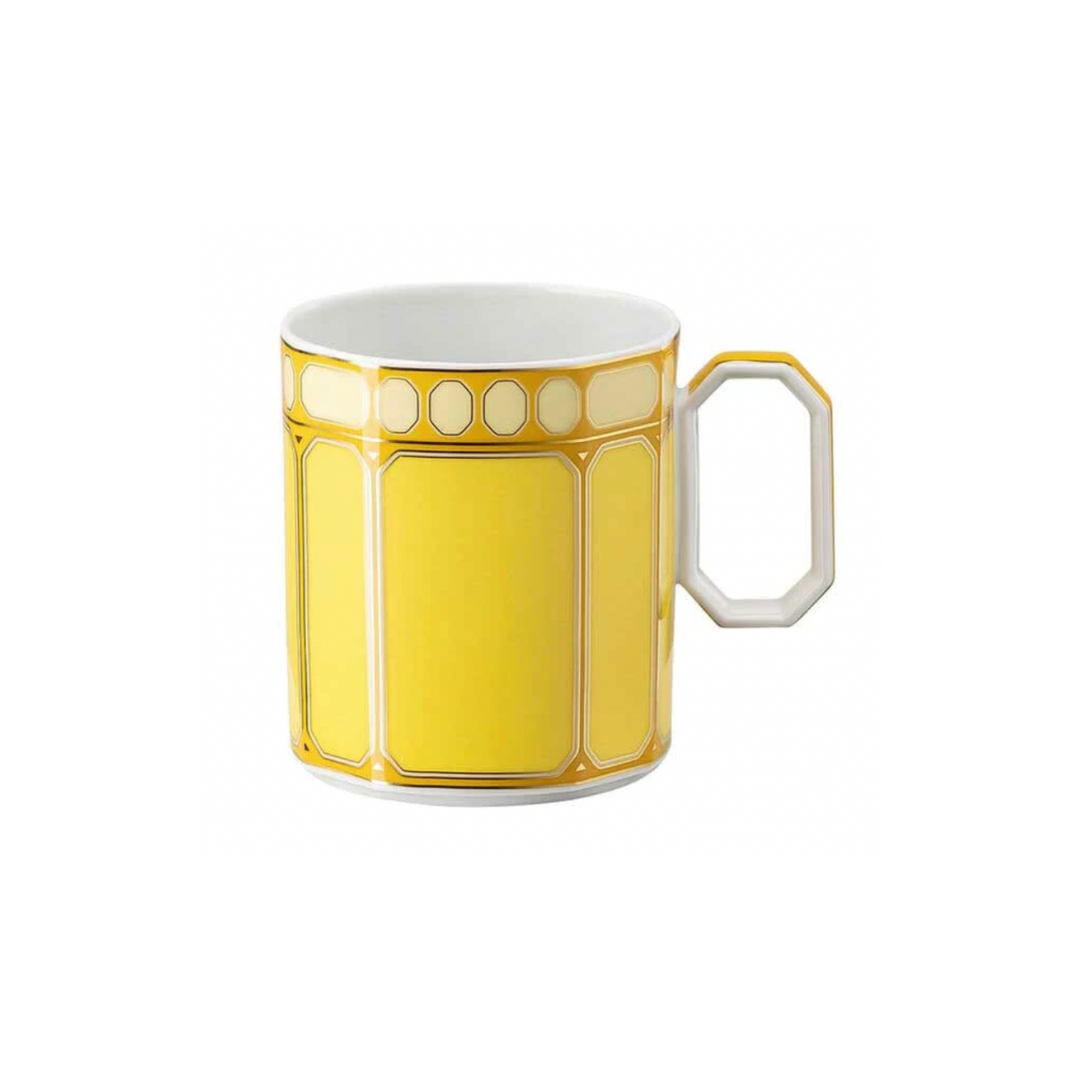 The Swarovski Signum Jonquil Yellow Mug by Swarovski x Rosenthal features a bright yellow geometric pattern and a unique angular handle, set against a plain white background.