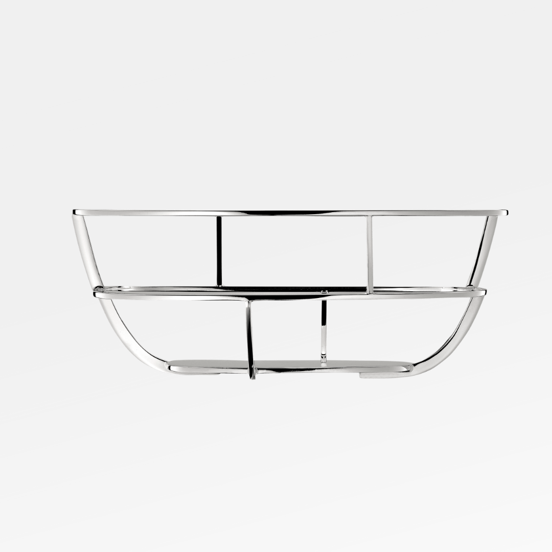 The Christofle Silver Time Bread Basket features a modern, chrome-plated design with a sleek oval shape—ideal for stylishly serving bread or displaying fresh produce.