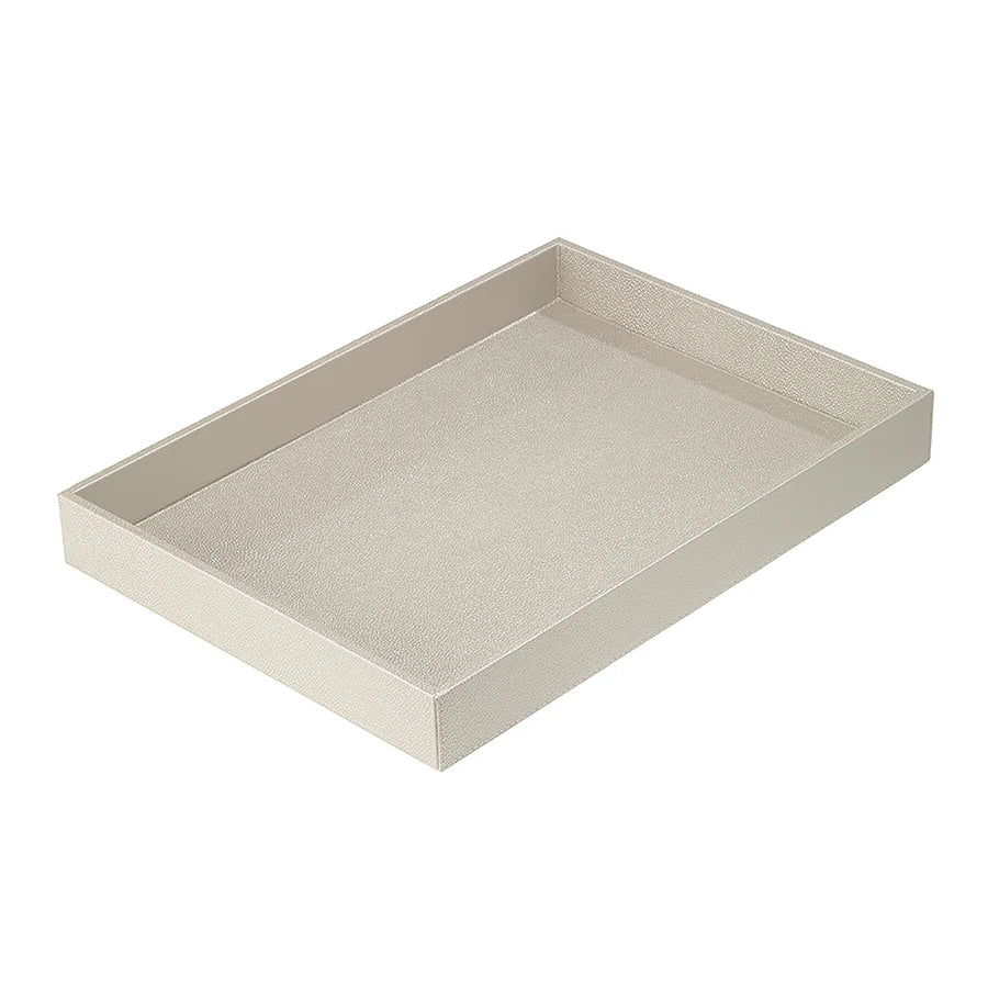 The Bodrum Skate Rectangle Tray, shown empty on a white background, is light beige with short raised edges. This phthalate-free tray features a subtle textured surface and a rectangular shape.
