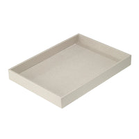 The Bodrum Skate Rectangle Tray, shown empty on a white background, is light beige with short raised edges. This phthalate-free tray features a subtle textured surface and a rectangular shape.