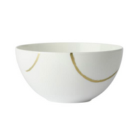 The Royal Crown Derby Sketch Chalk Dinnerware is a white ceramic bowl made in England, featuring simple gold curved lines as exterior decoration.