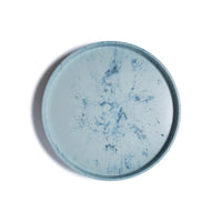 The Trashy Goods Smart Lazy Susan is a round tray with a light blue background and darker blue marbled patterns, perfect as a sustainable organizer or upcycled serving tray, shown from above on a white surface.