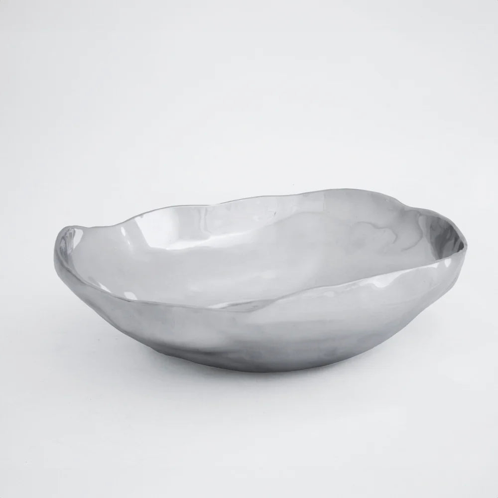 The Beatriz Ball Soho Nueve Organic Bowl 12.5" is a handcrafted, shallow bowl with a smooth, reflective silver finish. Eco-friendly and modern, it brings elegant style to any setting and looks striking against a plain white background.
