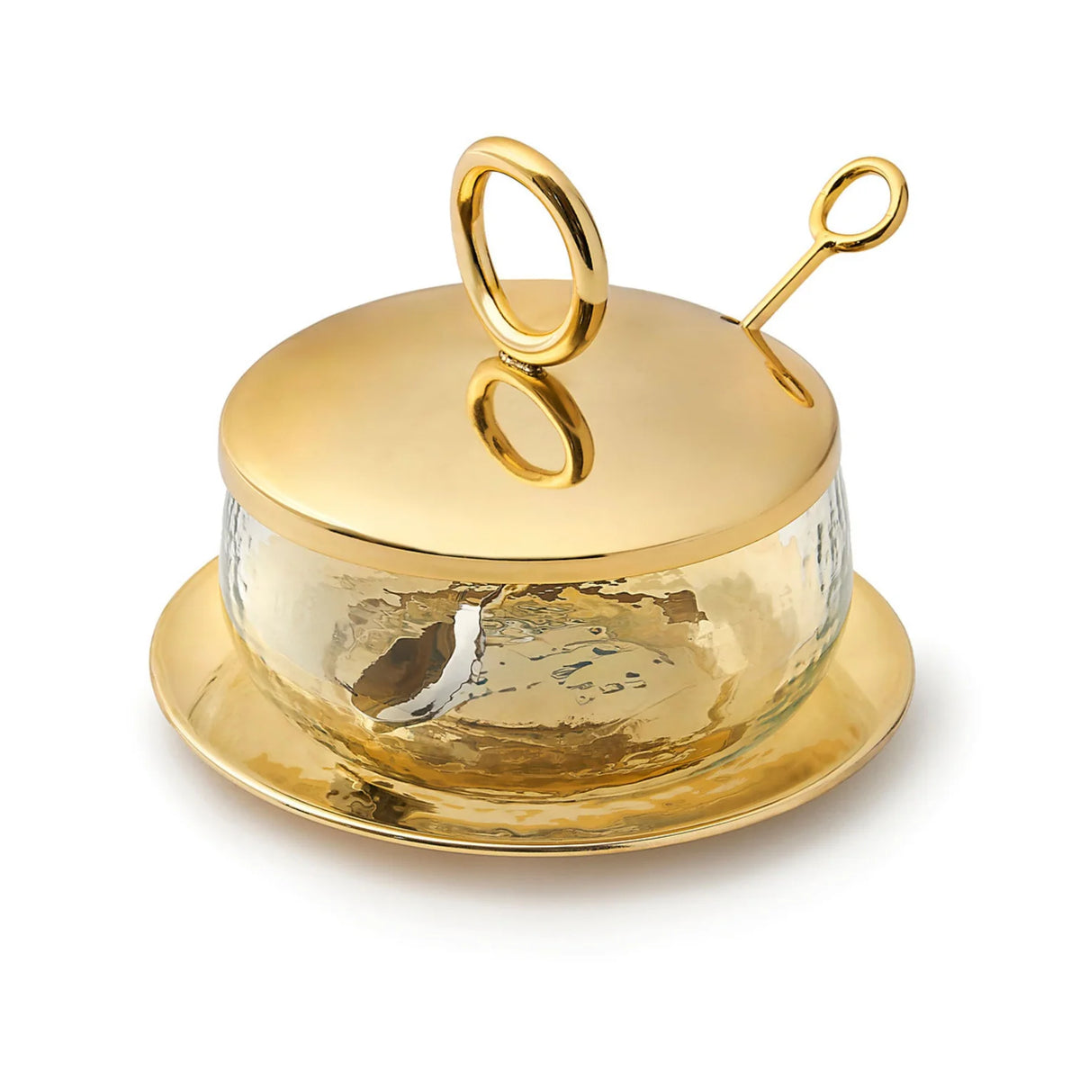 The Godinger Sphere Condiment Set Gold includes a round glass jar with a gold-toned hammered metal lid and matching spoon, both with circular handles, all resting on a gold-toned saucer for an elegant serving arrangement.