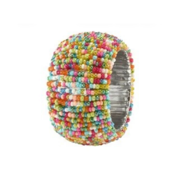 The Bodrum Candy Sprinkles Napkin Ring Set of 4 features wide, stretchy rings covered in small, multicolored beads on a silver base—perfect for adding a pop of color to your festive table setting.