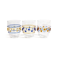 Three Festa Tumblers by Zodax in green, amber, and blue tones, each adorned with wavy lines and dots, are displayed side by side on a white background. Crafted from soda lime glass, this vibrant stemless drinkware adds flair to any setting.