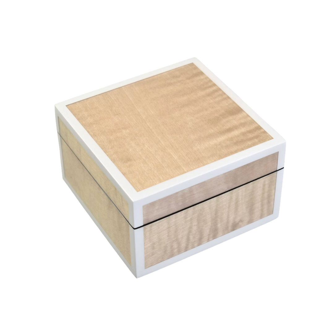 A small, square Sycamore Box With Silver Trim by Pacific Connections, featuring light wood grain panels and a white border, photographed on a white background.