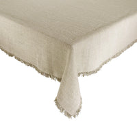 The Kim Seybert Fringe Tablecloth in Natural & Silver is a rectangular linen tablecloth with a slightly rough texture and short fringe along the edges, adding farmhouse chic style to your table.